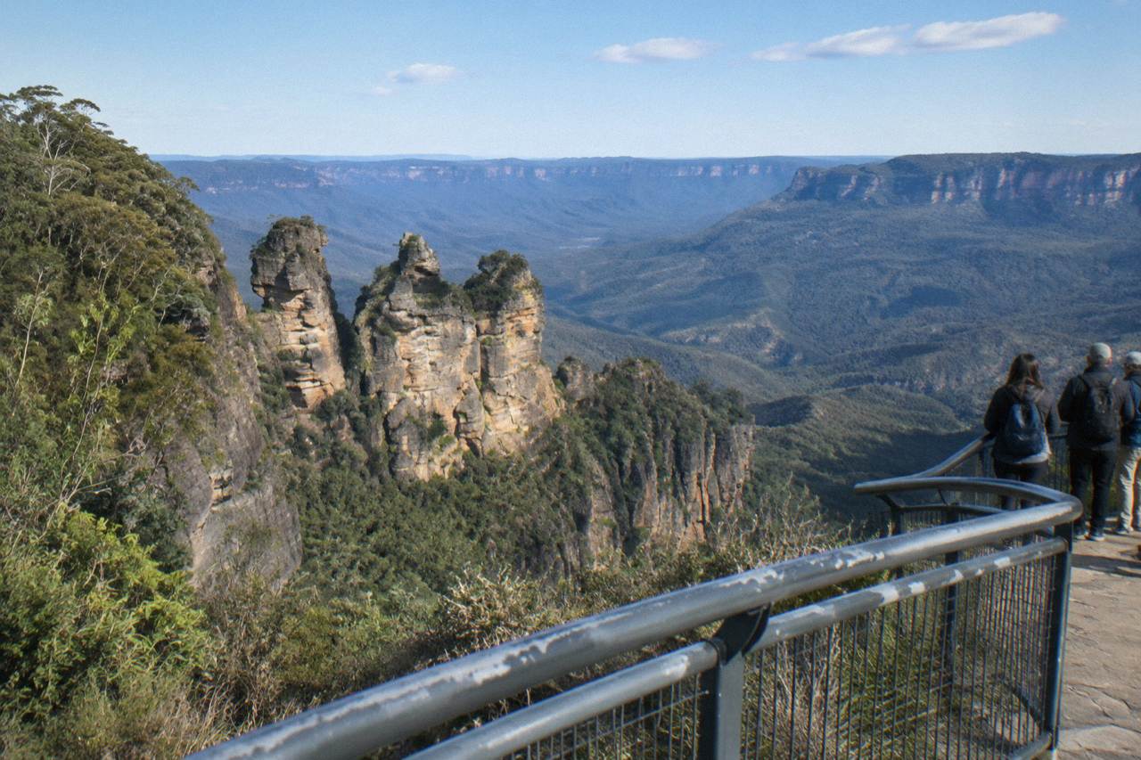 Sandstone cliffs and forested valleys of the Blue Mountains seen from a lookout on a clear day