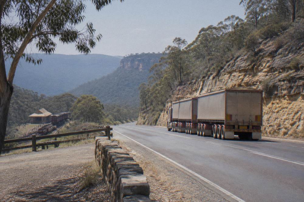 An old single-lane railway tunnel entrance framed by sandstone cliffs in Wollemi National Park