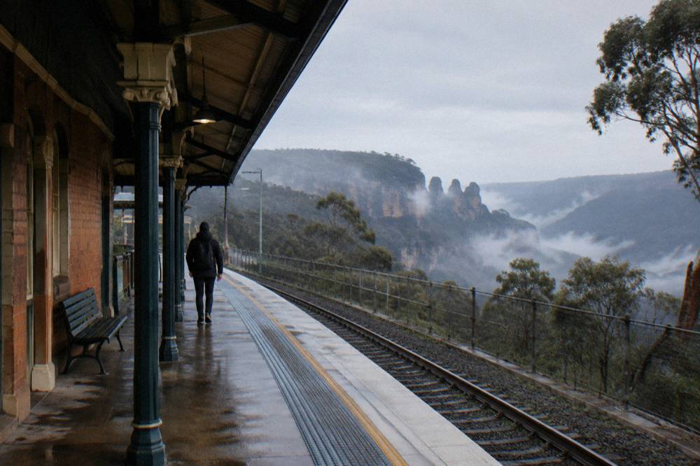 A Blue Mountains train platform in the early morning with mist over the valley