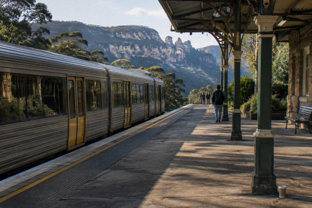 Country passenger train at a Blue Mountains station platform in late afternoon light